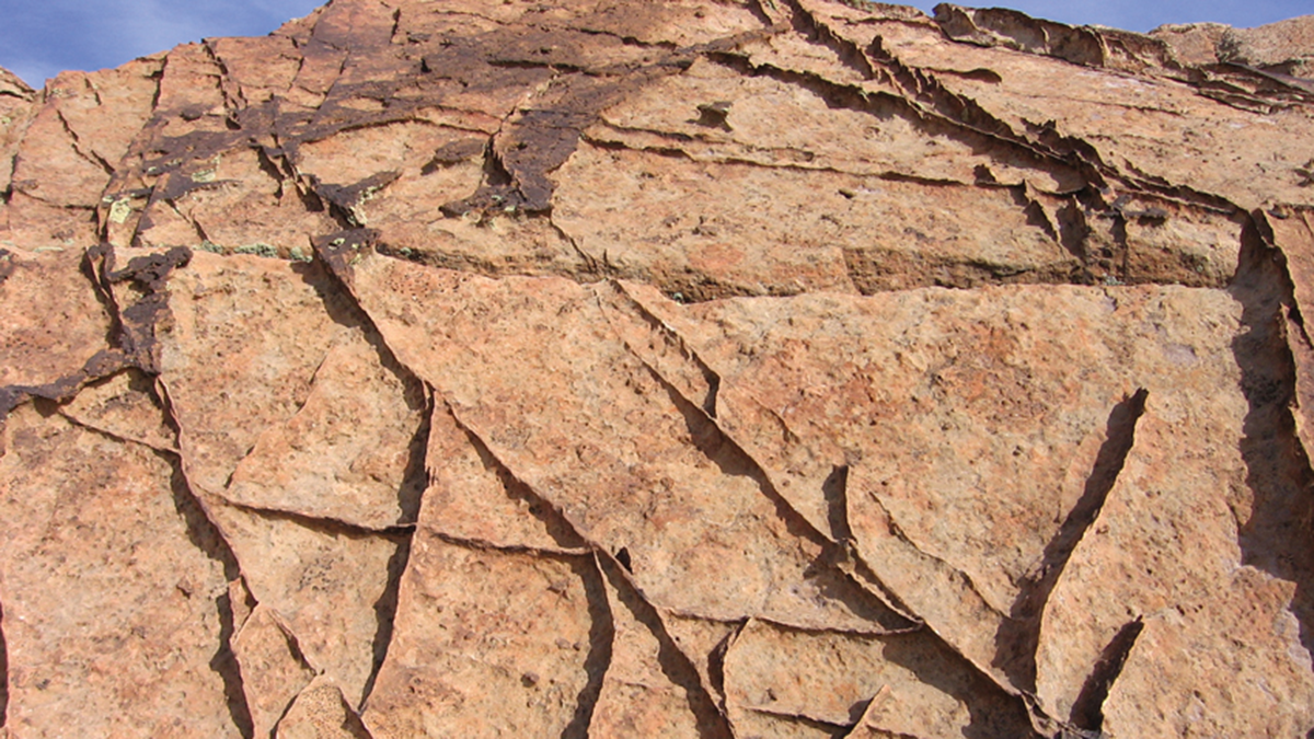 From Grains to Bands: Modeling Deformation in Porous Rocks