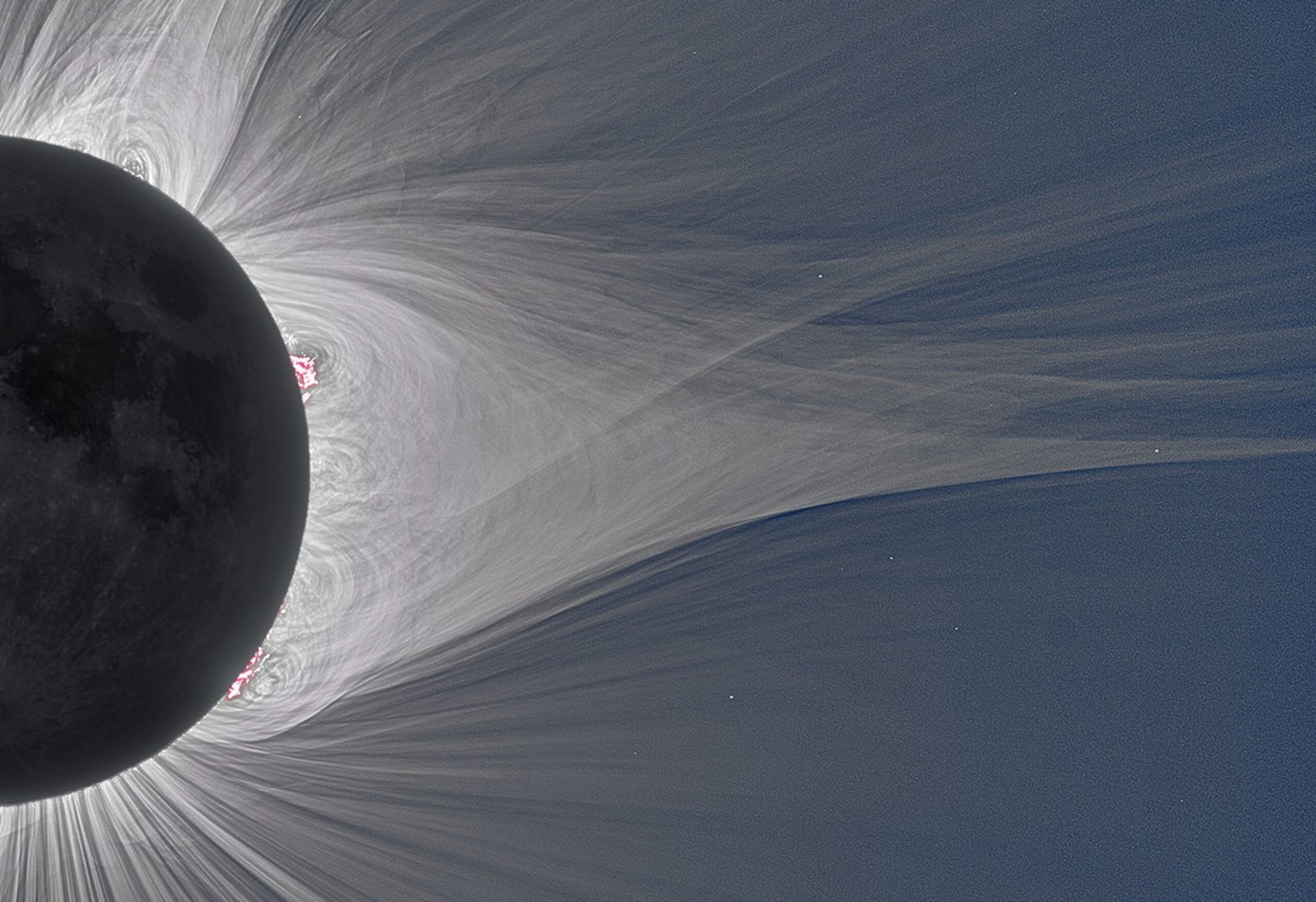 An extreme close-up photograph captures a detailed view of a total solar eclipse, showing the edge of the dark Moon on the left and the intricate structure of the solar corona extending to the right. The Moon's silhouette reveals subtle surface textures, while vibrant pink solar prominences flare out from its edge. The surrounding solar corona appears as a dense network of fine, glowing white magnetic field lines and wispy streamers that loop and stretch across a dark blue sky. Tiny, distant stars are faintly visible through the outer edges of the coronal streams on the right side of the frame.