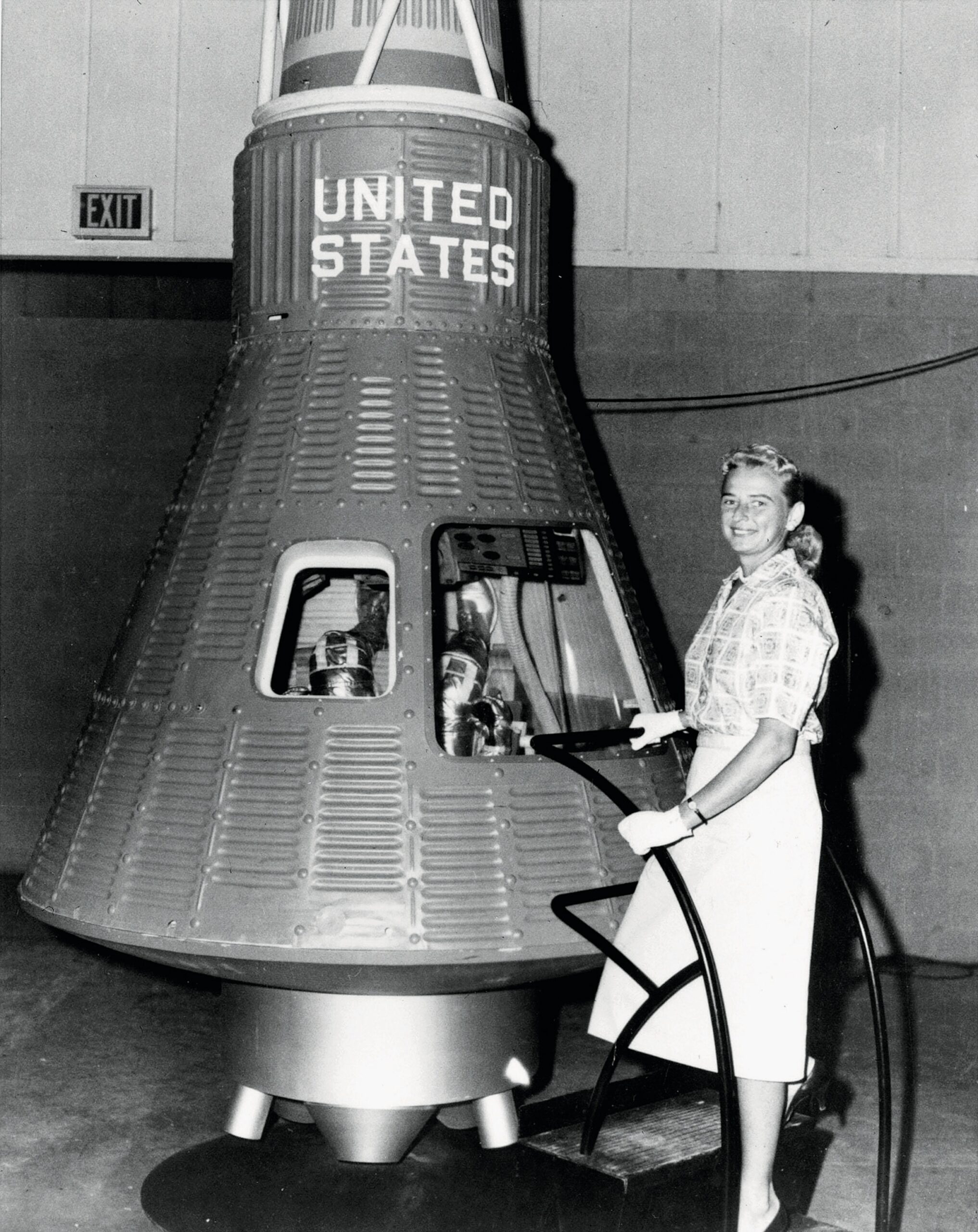Pilot Jerrie Cobb poses with the Freedom 7 Mercury capsule.