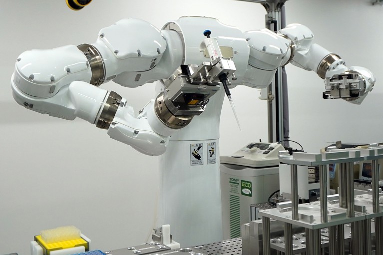 A Maholo LabDroid robot holding a pipette in its hand undertaking lab tasks.