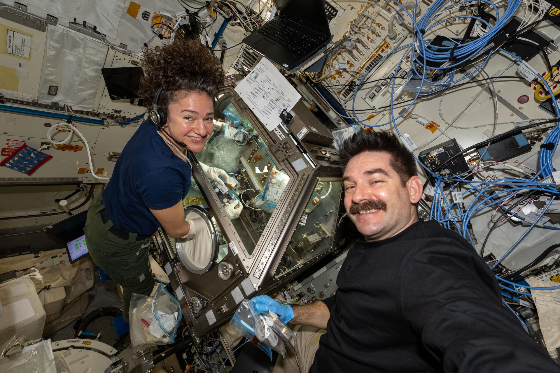 NASA astronauts Jessica Meir and Jack Hathaway, both Expedition 74 flight engineers, work together to process stem cell samples aboard the International Space Station’s Kibo laboratory module. Meir nourished the stem cells inside Kibo's Life Science Glovebox after Hathaway retrieved them from a science freezer, thawed them, and handed them over for treatment. The research may lead to the development of space-designed therapies to treat cancer and blood conditions.