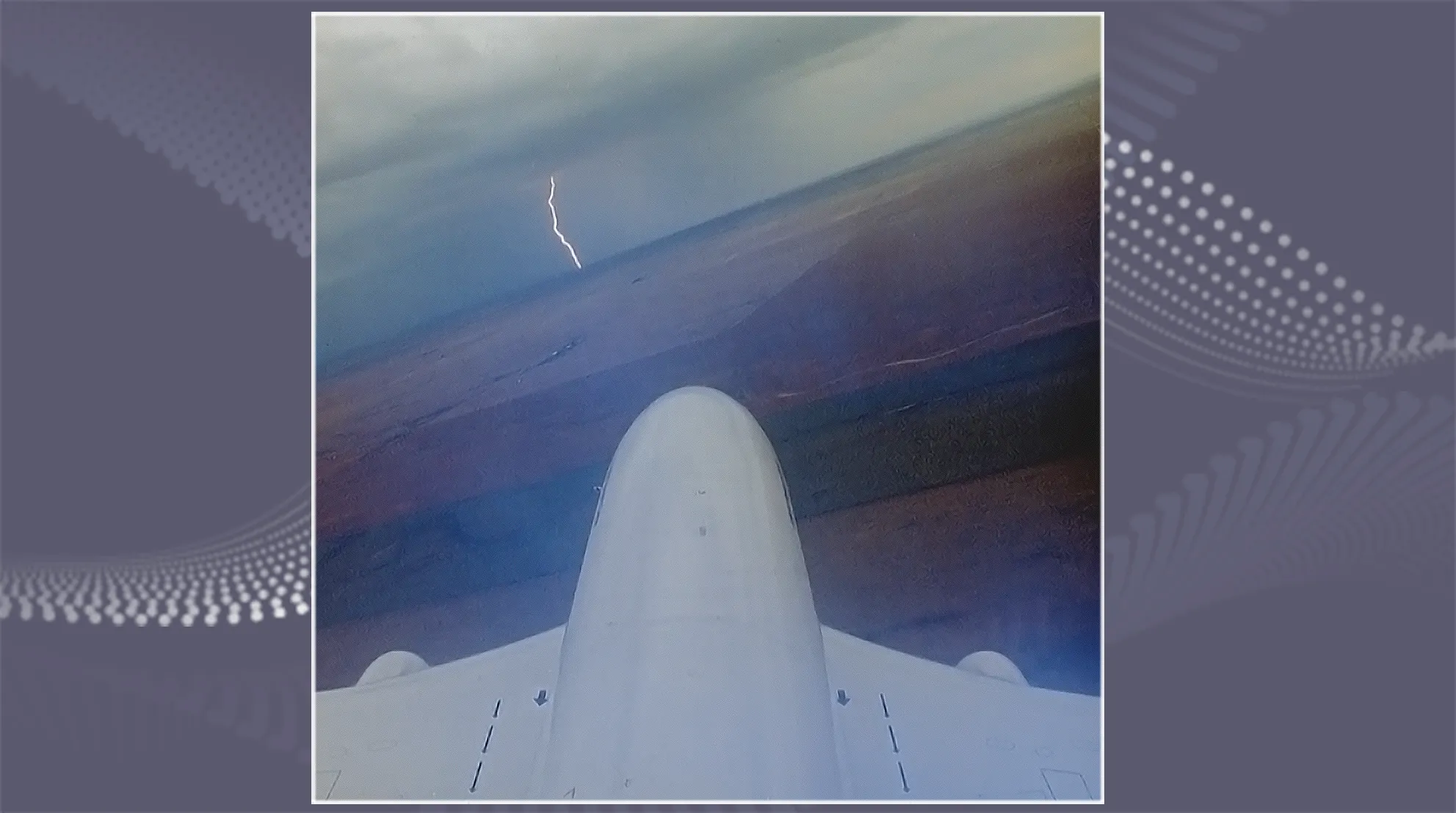 Boeing plane flying over water and a lighting strike can be seen in the distance.