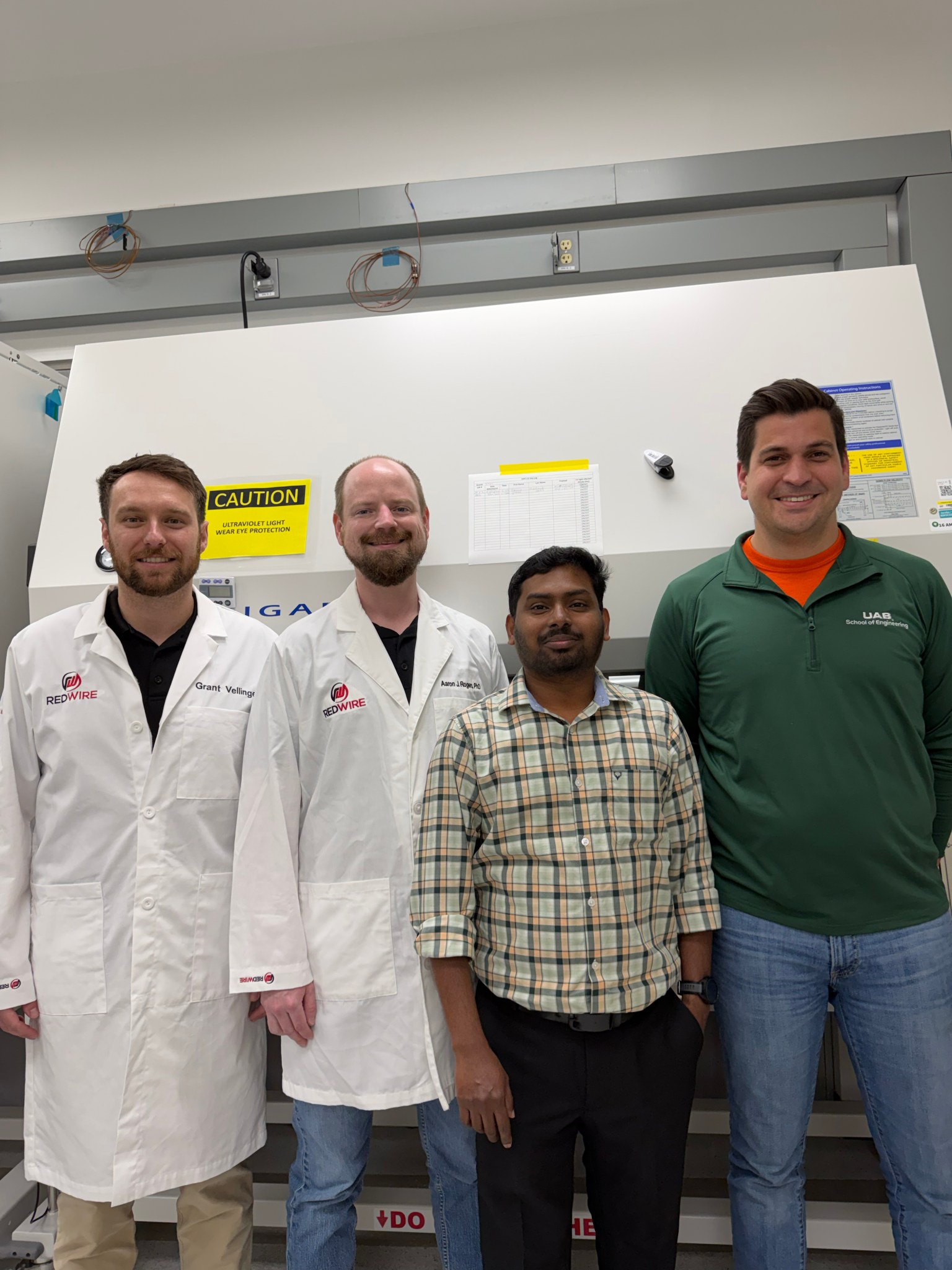 The MVP Cell-09 research team posts in a laboratory.