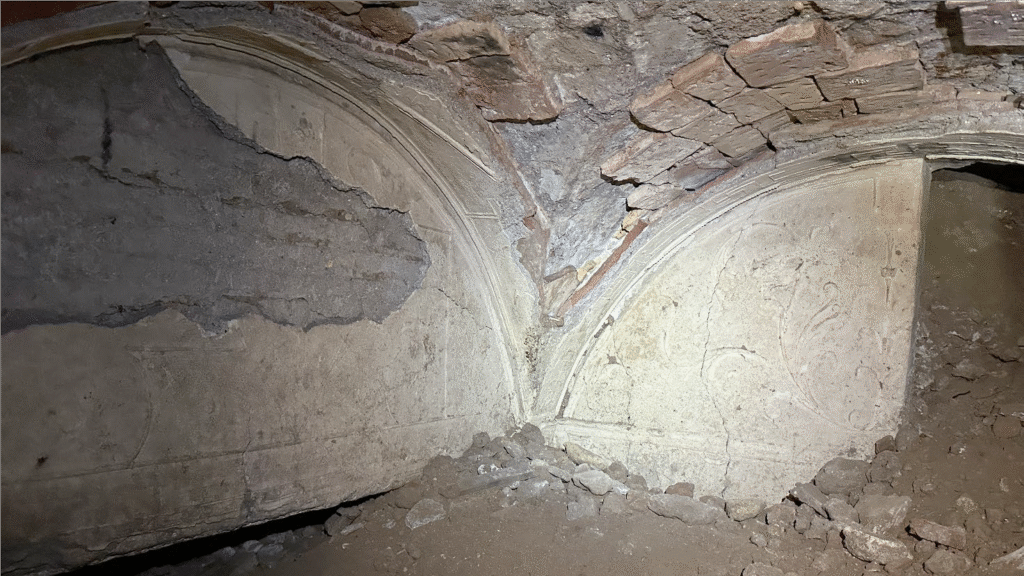 light colored stucco is preserved on ancient vaulted ceiling panels