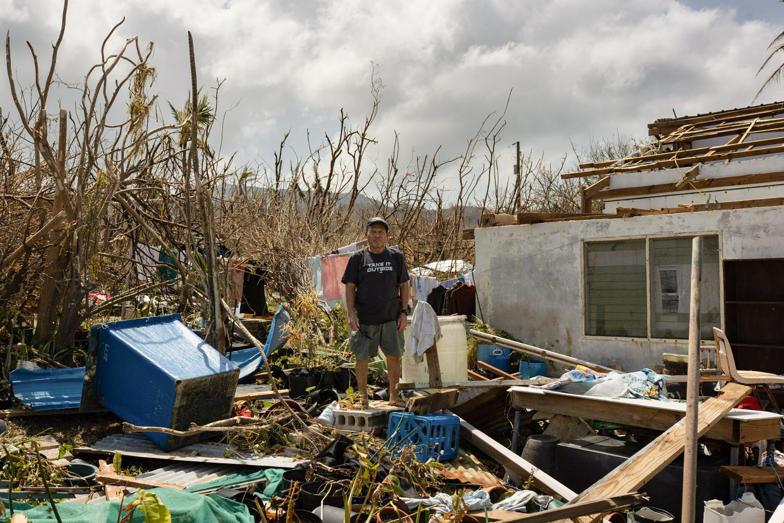 Just days after Typhoon Sinlaku, Micanor Uri Ranas stands in the remains of his home. Image by World Central Kitchen via Flickr (CC BY 4.0).