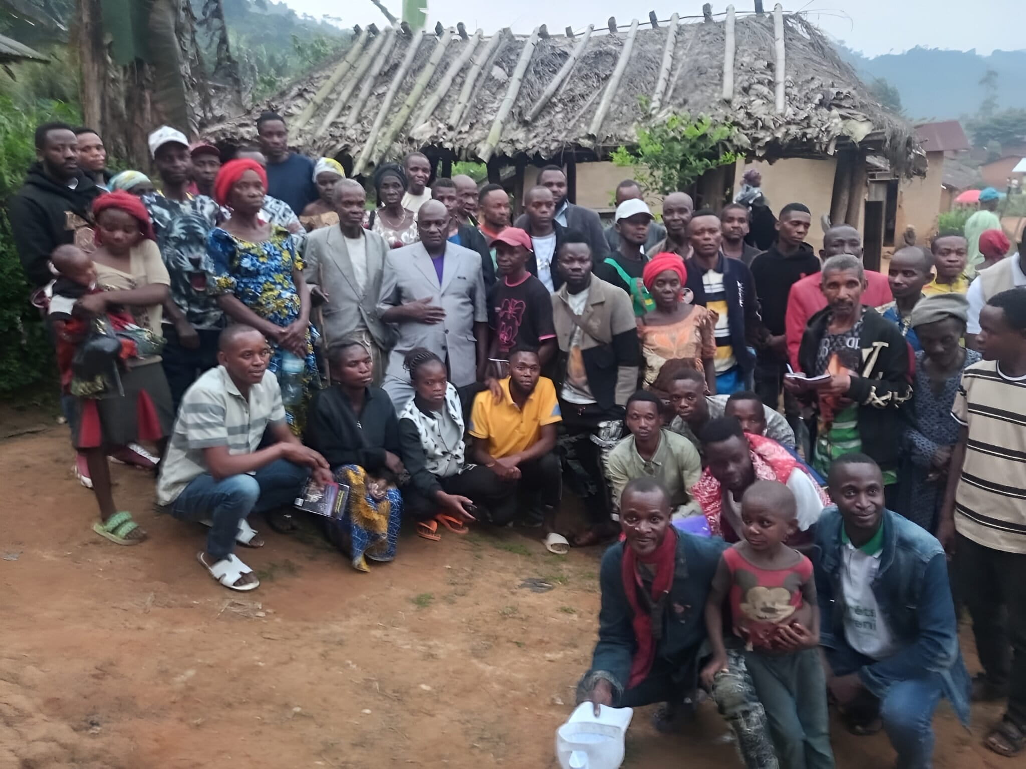 Gangala Yafali Mangusa Jr. and members of the Bamasobha community pose for a family photo after a community meeting on social cohesion within the Local Community Forest Concession (CFCL). Image by Jéremie Kyaswekera Kakule.