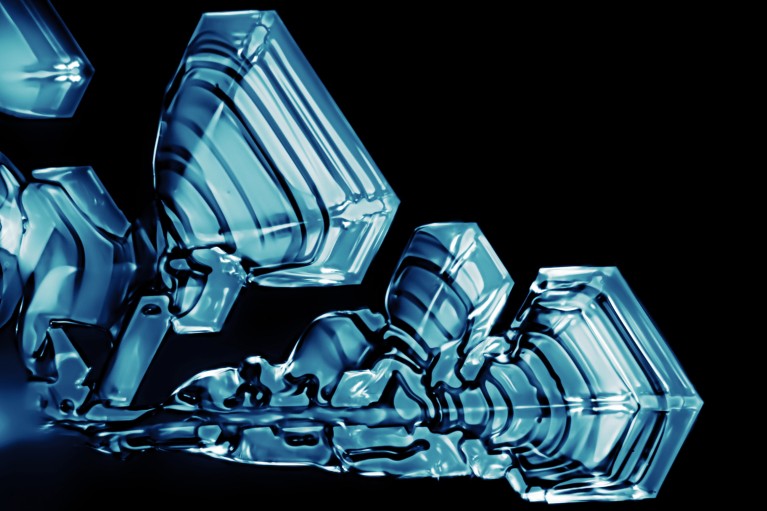 Ice crystals showing hexagonal symmetry grown under the light microscope at -45 degrees Celsius.