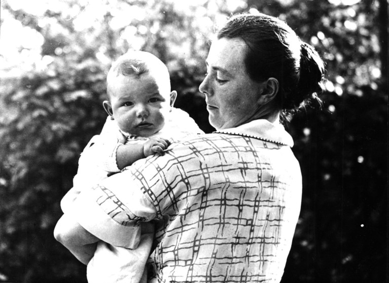 An archive black and white photograph of German biologist Hilde Proescholdt Mangold holding her baby