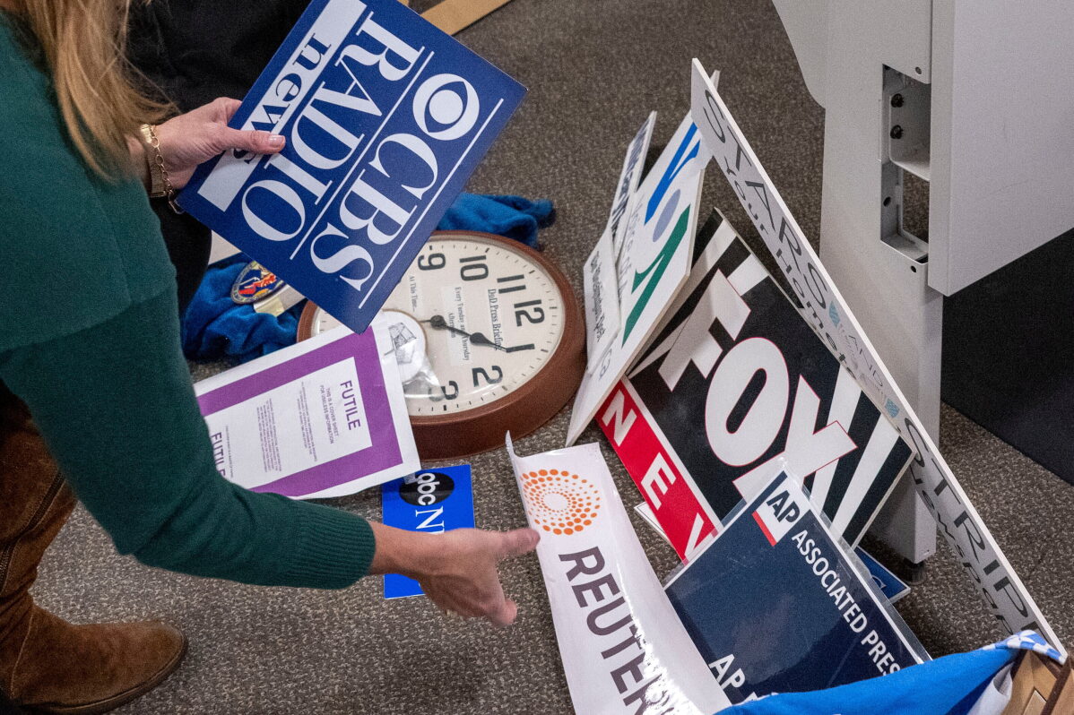 Washington Post reporter Tara Copp saves the name plaques from various news organizations as she and members of the media pack up their belongings in the press area in the Pentagon, Oct. 15, 2025 in Washington. (AP Photo/Kevin Wolf, File)