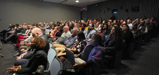 Senior members of the Office of Procurement gather for a presentation
