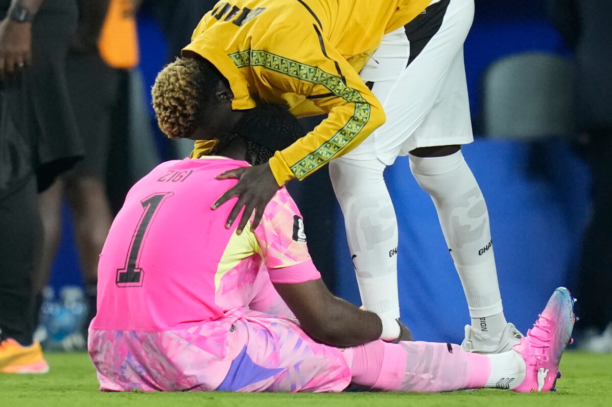 Ghana goalkeeper Lawrence Ati-Zigi (1) is comforted by teammate Kojo Peprah Oppong (21) after the World Cup round of 32 soccer match between Colombia and Ghana in Kansas City, Mo., Friday, July 3, 2026. (AP Photo/John Locher)